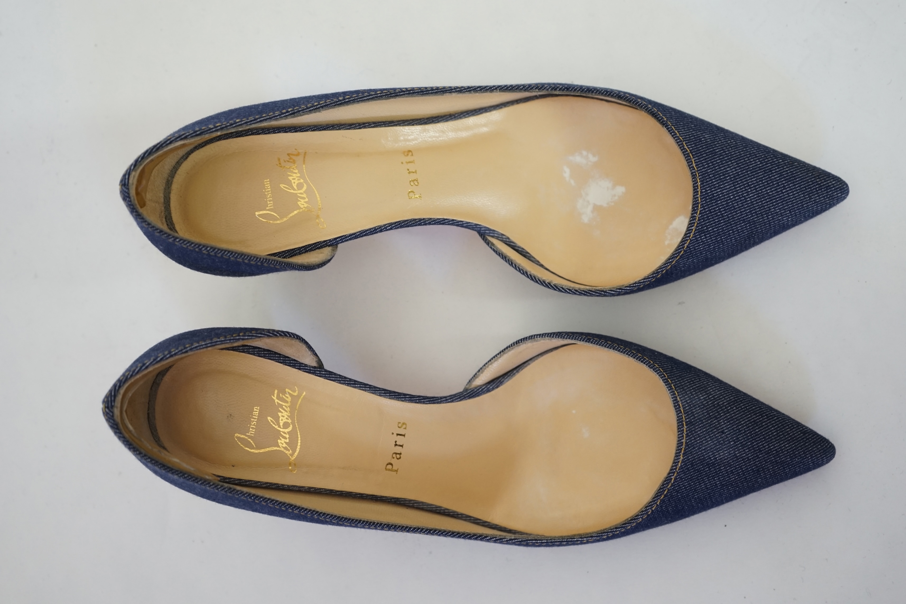 A pair of Christian Louboutin lady's denim pumps with wooden heels, comes with dust bag in original box. Size 39. Proceeds to Happy Paws Puppy Rescue